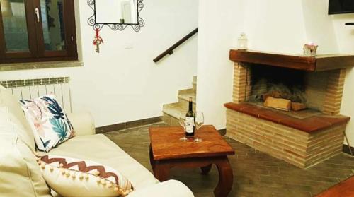 a living room with a couch and a fireplace at La casa di Olivia in Rocca di Cambio