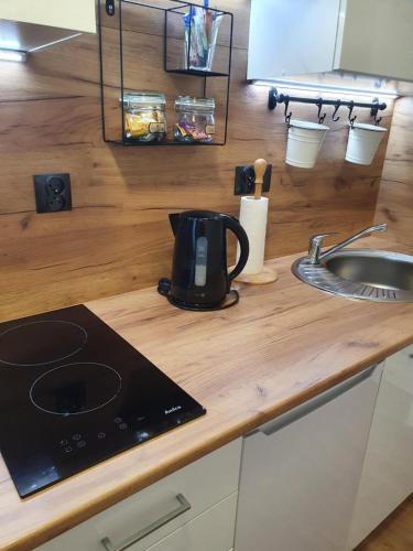 Moti Apartments في كراكوف: وجود آلة صنع القهوة على منضدة بجانب حوض