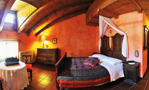 a bedroom with a large bed in a room at Albergo Locanda Mezzosoldo in Mortaso