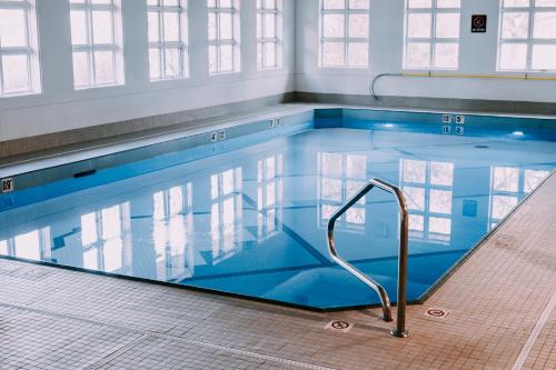 a large swimming pool with a hand rail in it at Coast Canmore Hotel & Conference Centre in Canmore