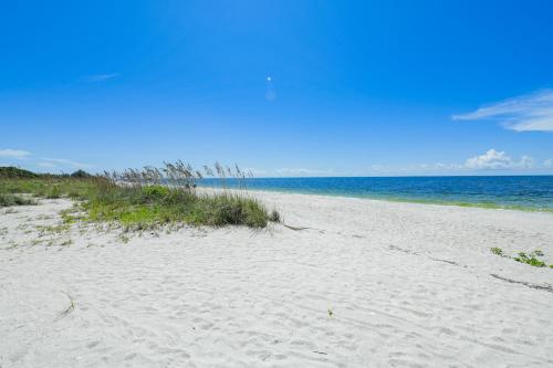 a sandy beach with the ocean in the background at Casey Key Resorts - Beachfront in Venice