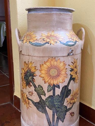 a vase with a painting of flowers on it at El Abigero in La Fregeneda