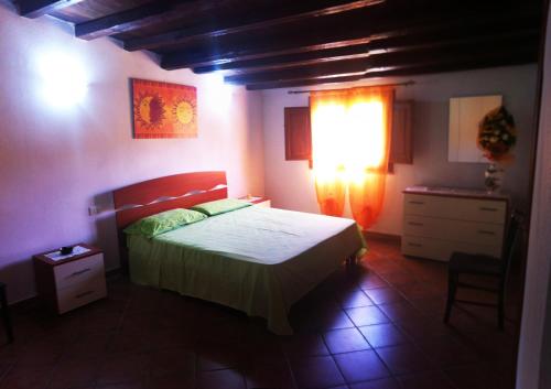 A bed or beds in a room at Case Vacanza Teulada
