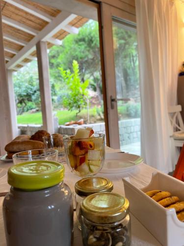 a table with jars and a box of food on it at ALELCA DOMO in Buggerru