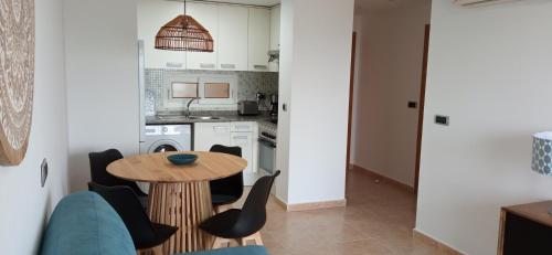 a kitchen and dining room with a table and chairs at SAHARA BEACH, sunrise & mediterranean sea views in La Manga del Mar Menor