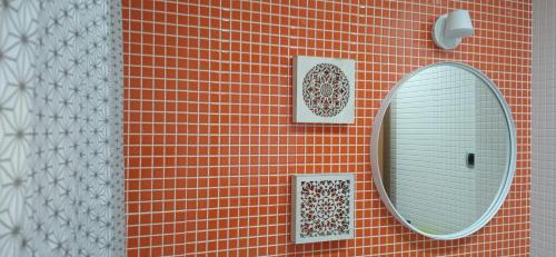 a mirror on the side of a red brick wall at SAHARA BEACH, sunrise & mediterranean sea views in La Manga del Mar Menor