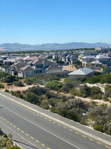 a view of a city with houses and a highway at Waves Edge CP3 in Cape Town