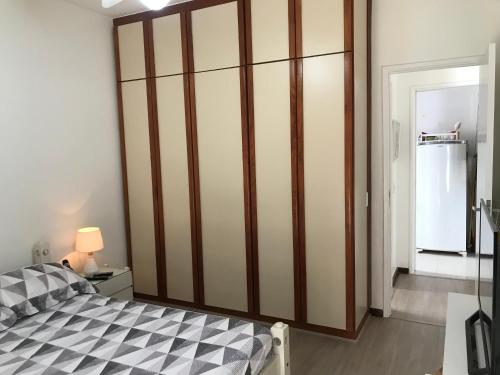 a bedroom with a large closet with a bed at Flat Golden Coast in Rio de Janeiro