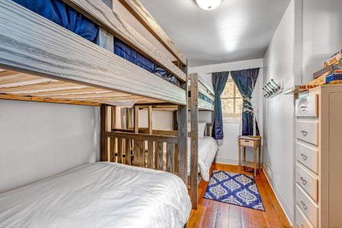 two bunk beds in a small room with wooden floors at Brighton Sunflower Chalet in Brighton