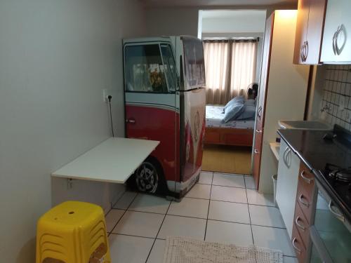 an old red and white van parked in a kitchen at Cantinho da Paz in Brasília