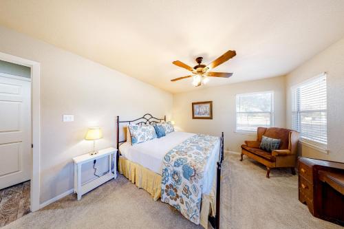 a bedroom with a bed and a ceiling fan at Woodlands Wonder in Fredericksburg