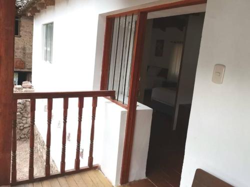 an open door to a room with a balcony at APARMENT SAMANA HOUSE OLLANTAYTAMBO in Ollantaytambo
