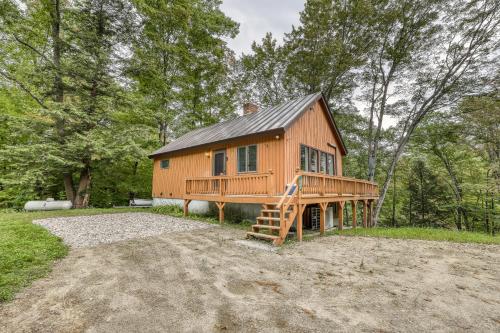 a large wooden house in the middle of a field at Ludlow Comfy Cabin in Ludlow