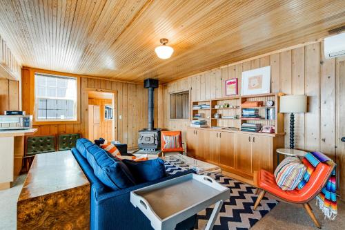 a living room with a blue couch and a table at Sunrise Beach House in Gig Harbor