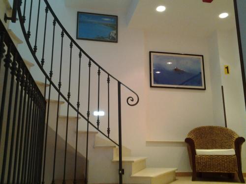 a stairway with a stair railing and a stair case at History Hotel in Valderice
