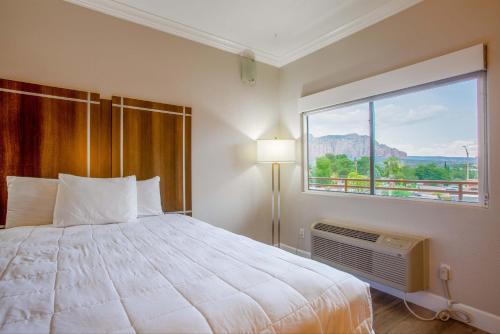 a bedroom with a large bed and a large window at Wildflower Inn at Bell Rock in Sedona