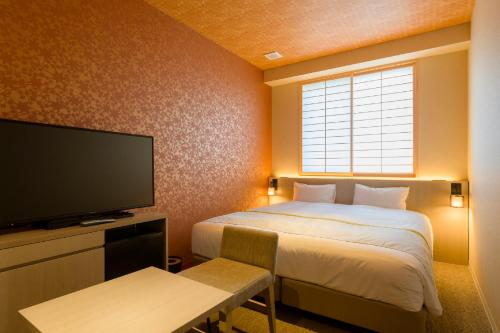 a hotel room with a bed and a television at Tosei Hotel Cocone Kamakura in Kamakura