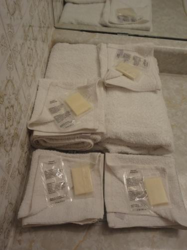 a pile of towels sitting on the floor in a bathroom at Empress Inn and Suites by the Falls in Niagara Falls