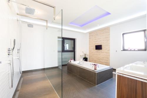 a bathroom with a bath tub and a sink at Luxury City Villa Trogir in Trogir