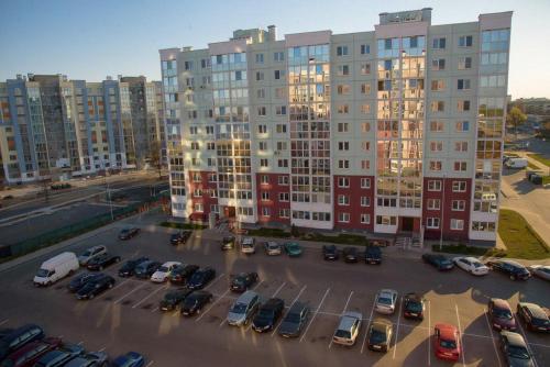 a parking lot in front of a large building at PaulMarie Apartments on Kozlova, 1A/2 in Salihorsk