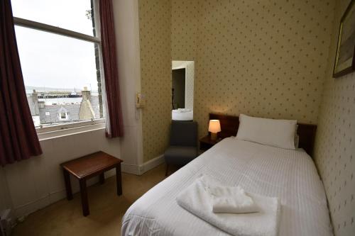 a hotel room with a bed and a window at The Stromness Hotel by Paymán Club in Stromness