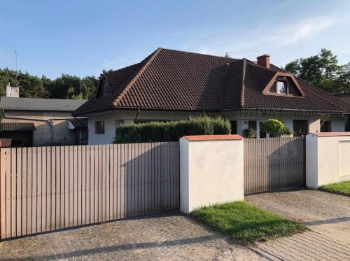 a fence in front of a house at Pokoje Gościnne Sonia in Tuszyn