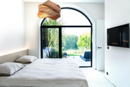 Ένα ή περισσότερα κρεβάτια σε δωμάτιο στο Wellness Suite B&B L'O Reine