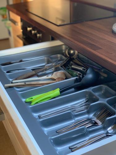 a drawer filled with cooking utensils in a kitchen at Ubytování U MAXÍKA in Suchdol nad Lužnicí