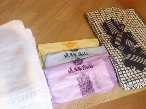 a pile of towels sitting on top of a floor at Oyado Hachibei in Takayama