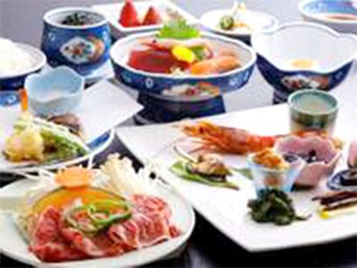 a table with many plates of food on it at Oyado Hachibei in Takayama