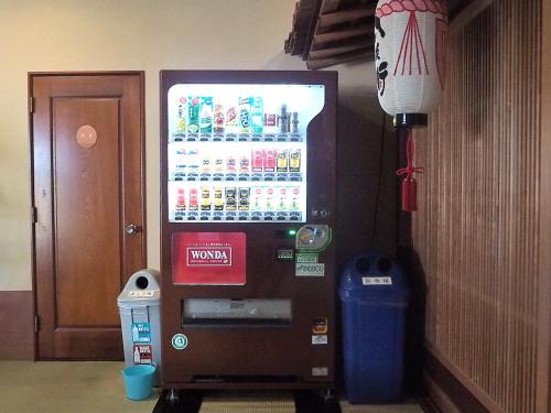 a vending machine with a drink cooler in a room at Oyado Hachibei in Takayama