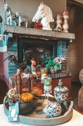 a room with a fireplace with a table with a fireplace at Hoeve Westdijk in Oostkamp