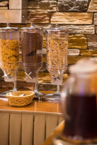 four wine glasses filled with food on a table at Anastazia Luxury Suites & Spa in Athens