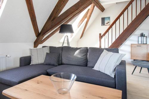 a living room with a couch and a wooden table at Ferienwohnungen im Weingarten Quedlinburg in Quedlinburg