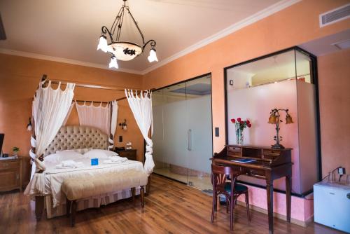 a bedroom with a bed and a desk and a piano at Anastazia Luxury Suites & Spa in Athens