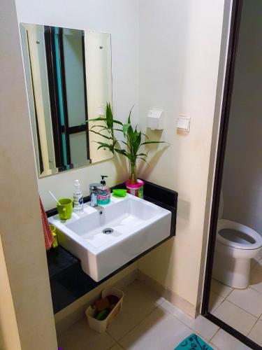 a bathroom with a white sink and a mirror at Aloha Guest House 2 - Female Only in Tangerang