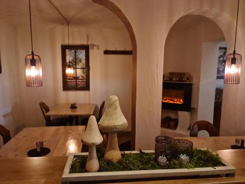 two mushrooms on a table in a room with a fireplace at Gasthof Wolfs Stuben in Reichenbach an der Fils