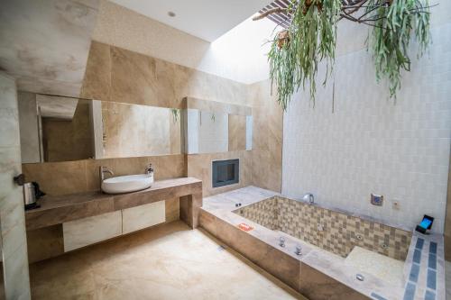 a bathroom with a tub and a sink at Region Motel in Lugang