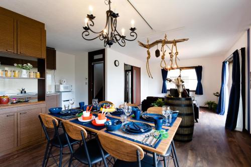 a dining room with a table with blue dishes on it at Wave House Kujukuri Shimokaizuka Beachside - Self Check-In Only in Kujukuri
