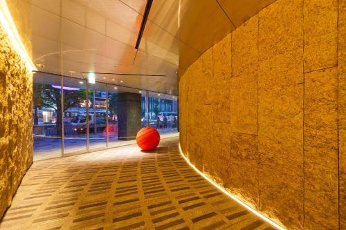 a orange ball sitting on the floor of a building at remm Kagoshima in Kagoshima