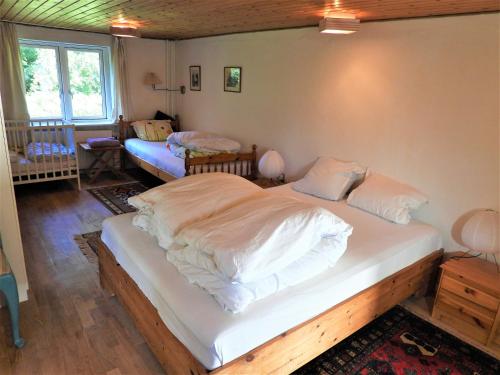 1 dormitorio con 1 cama grande con sábanas blancas en Engbjerg BnB en Hirtshals