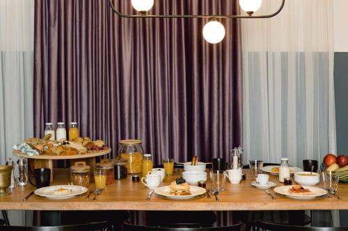 a long table with plates of food on it at NAIADES the residence ioannina castle in Ioannina