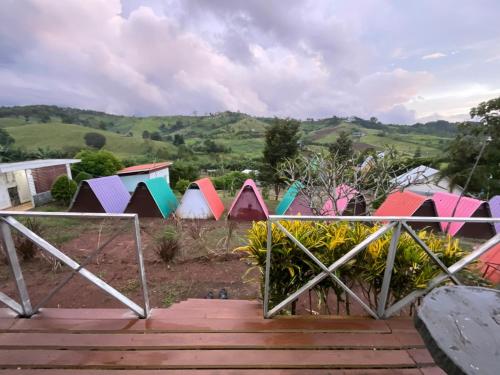 a group of colorful tents in a field at ภูน้ำทิพย์ รีสอร์ท in Ban Huai Phai
