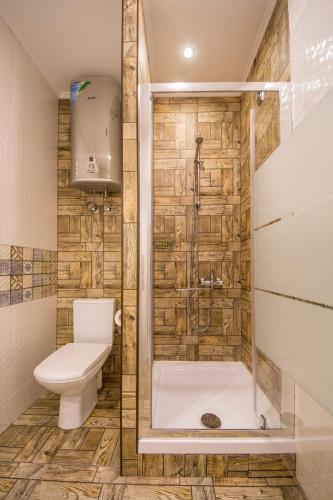 a bathroom with a toilet and a shower at Idea Design Apart-Hotel in Kyiv