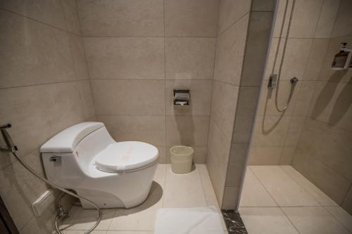 a bathroom with a toilet and a shower at Region Motel in Lugang