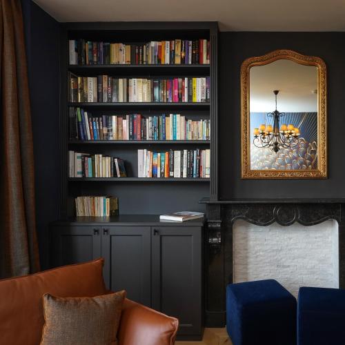 a living room with a book shelf filled with books at Les Terrasses des Falizes B&B in Rochefort