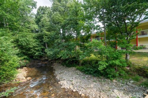 a road in front of a building with trees at Ramada by Wyndham Maggie Valley in Maggie Valley
