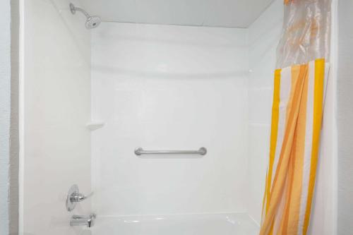a shower in a bathroom with a shower curtain at La Quinta by Wyndham Joplin in Joplin