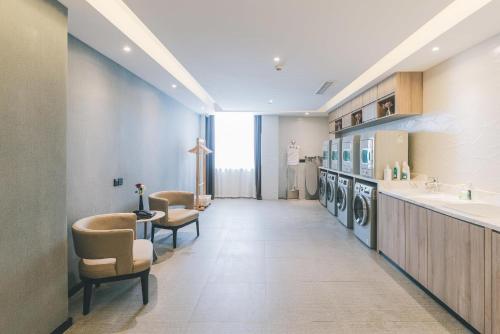a laundry room with a sink and washing machines at Atour Hotel Kunshan Yongda Business Plaza in Kunshan