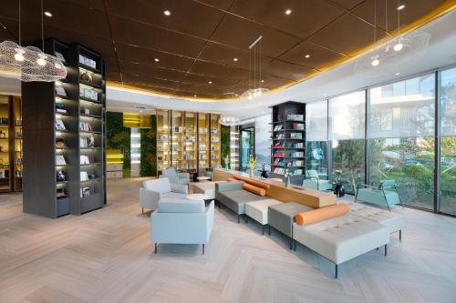 a wine store with couches and chairs and windows at Atour Hotel Yan'an Luyi Park in Yan'an